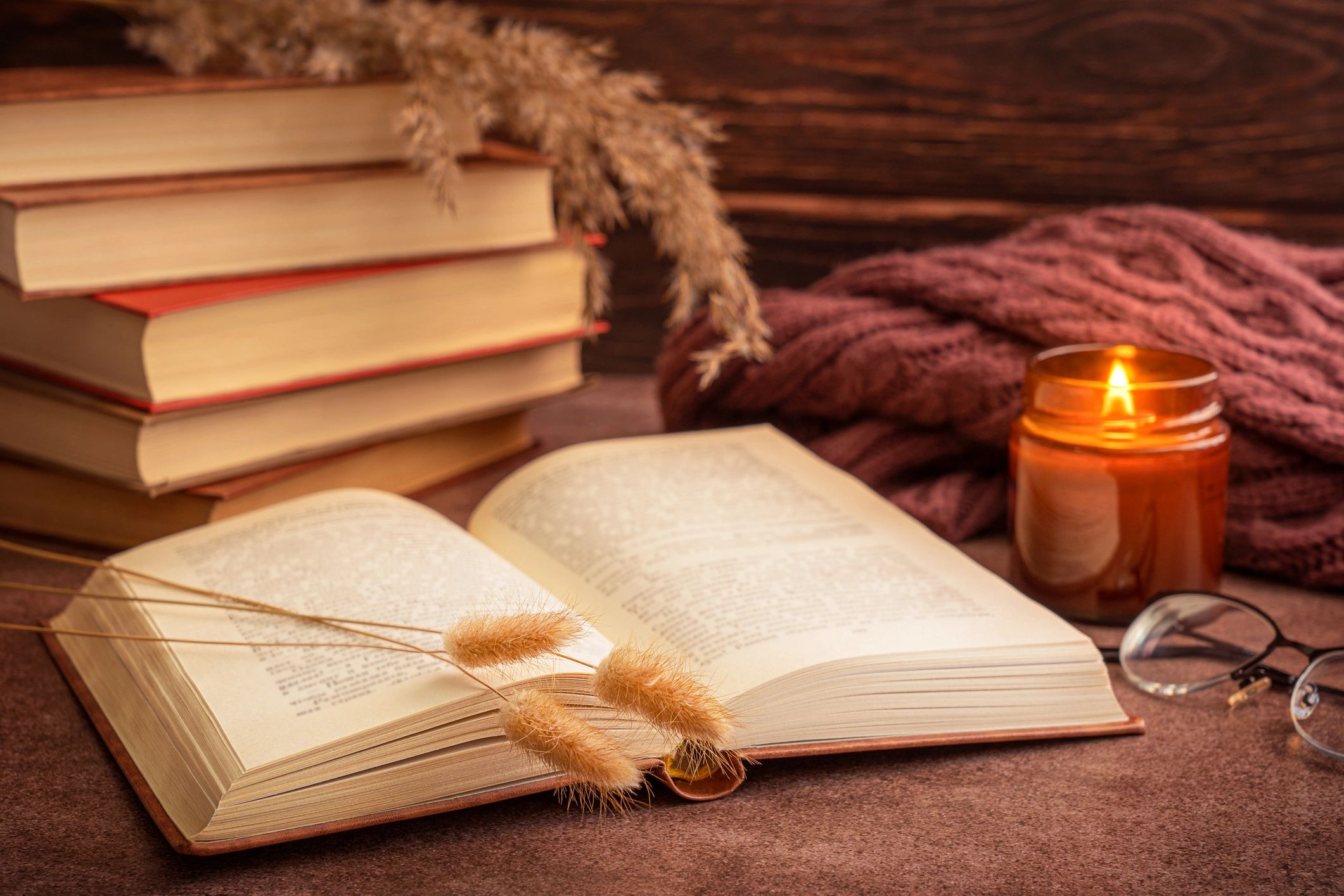 Open book in a warm, candlelit reading corner