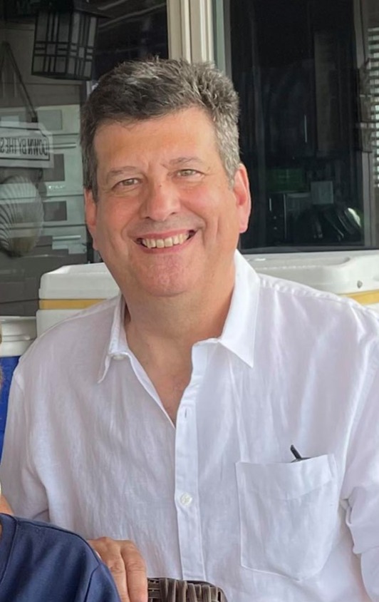 Michael J. Iantosca smiling in a white collared shirt